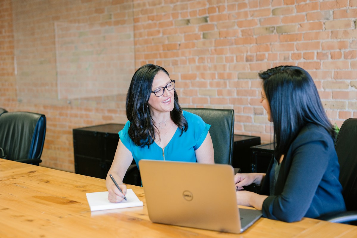 Two professionals discussing ideas at a table